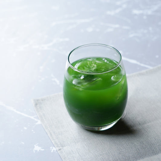 Nakamura Tokichi Uji Matcha Sweetened green tea mix in a glass cup with ice.