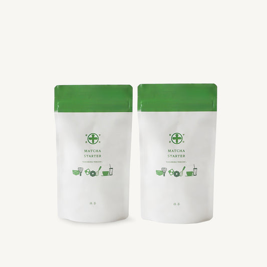 Two 100g pouches of Nakamura Tokichi Matcha Starter green tea powder. Authentic Japanese matcha in white stand-up bags with the Maruto logo.